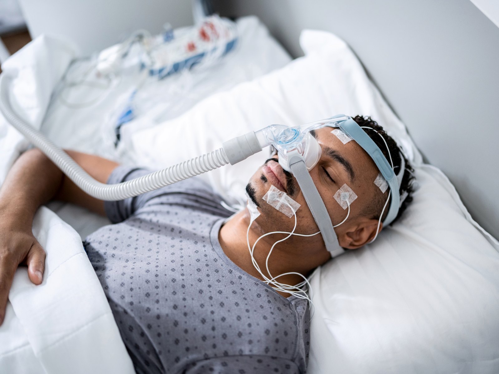 Patient wearing a breathing mask during an overnight sleep study