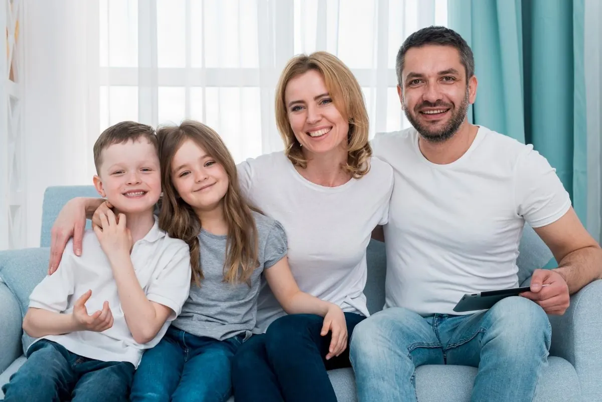 Family smiling together at home