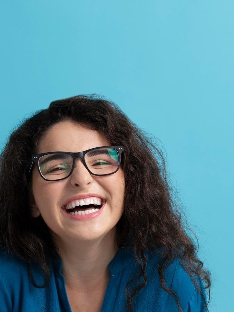 A patient smiling after orthodontic treatment at Dante Gonzales Orthodontics