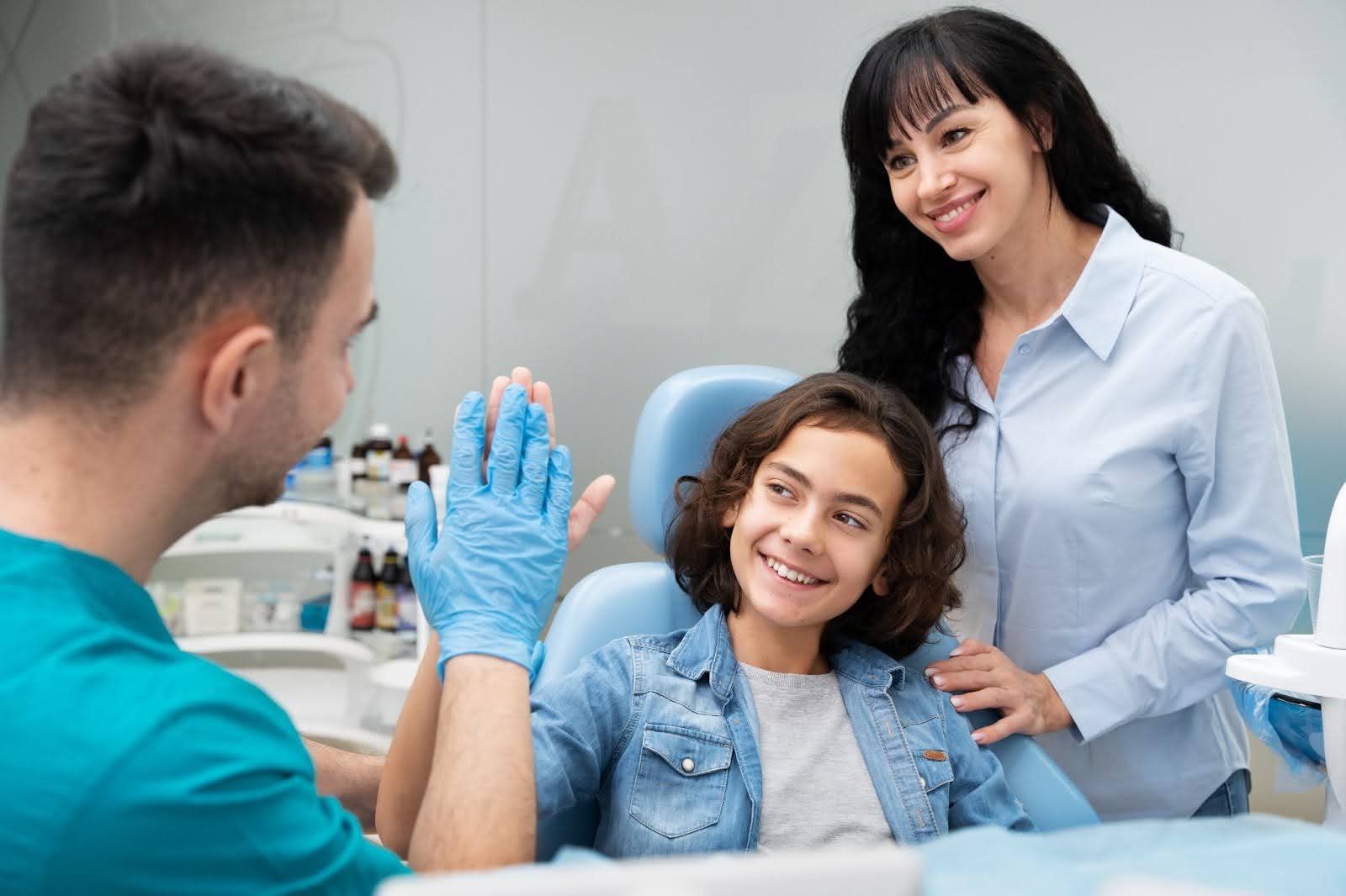 Orthodontist reviewing a treatment plan with a patient and their parent